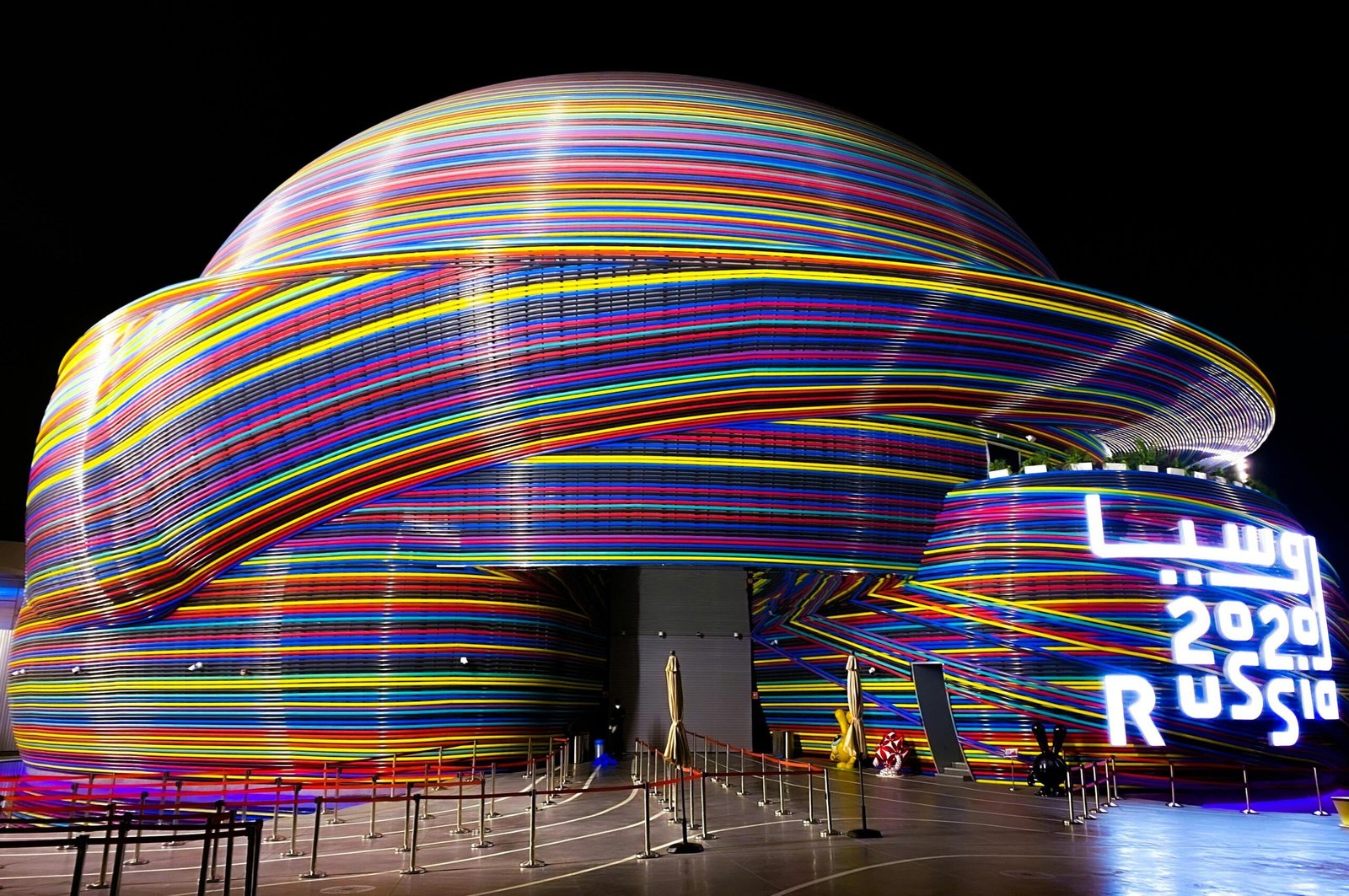 Vibrant neon-lit Russian Pavilion at Dubai Expo 2020, showcasing modern architecture.