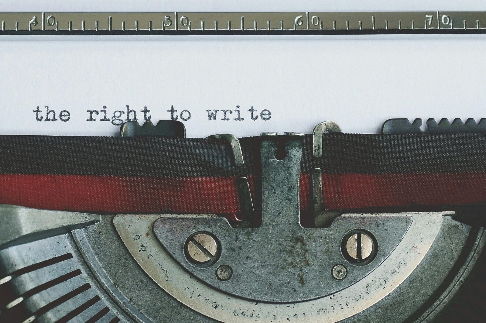 Close-up of a vintage typewriter with 'the right to write' typed on paper.
