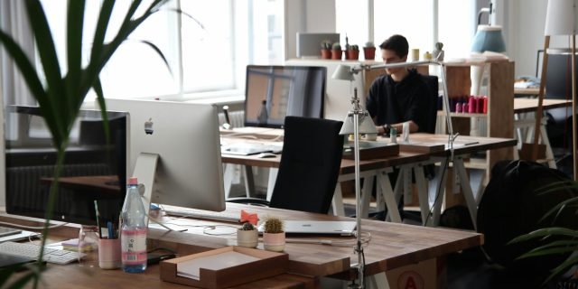 Open-plan office with modern decor and natural lighting, ideal for productivity.